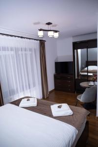 Ένα ή περισσότερα κρεβάτια σε δωμάτιο στο Pensiunea Agroturistica Panoramic
