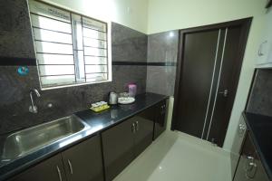 a small kitchen with a sink and a window at Taj homes stay in Tirupati +19 photos
