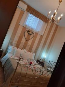 a bedroom with a bed and a chandelier at POMPEI HOUSE in Scafati