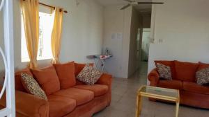 a living room with a couch and a table at Ventnor House Apartments in Bridgetown