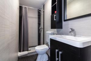 a bathroom with a white sink and a toilet at Petra Apartment in Rab +53 photos
