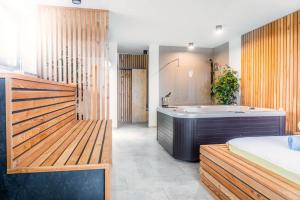 a bathroom with a tub and a sink and a bath tub at Apartments Sunrise Banovci in Banovci