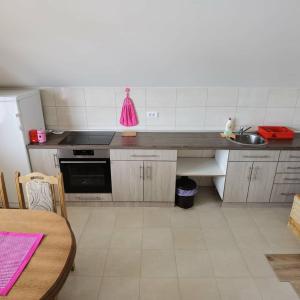 a kitchen with a sink and a stove top oven at Apartman Bambi Zlatar in Nova Varoš +13 photos
