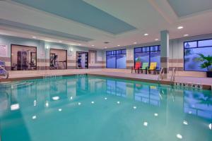 a large swimming pool in a hotel lobby at Holiday Inn Express Hotel & Suites Ottawa West-Nepean, an IHG Hotel in Ottawa