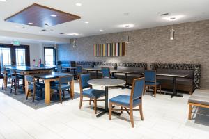 a dining room with tables and blue chairs at Holiday Inn Express Mill Valley San Francisco Area by IHG in Mill Valley