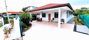 a small white house with a red roof at Kota Kinabalu Sabah City Homestay in Kota Kinabalu