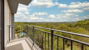 a balcony with a view of the woods at Oaks Sydney North Ryde Suites in Sydney