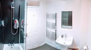 a white bathroom with a sink and a shower at Brookview 2BR Flat Oxford City Centre Free Parking in Oxford +20 photos