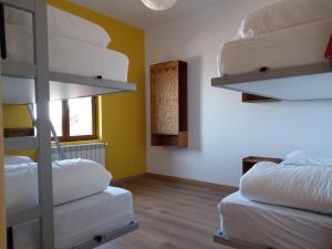 a room with two bunk beds and a window at Albergue Fresno de Cantespino - La Tormenta in Fresno de Cantespino