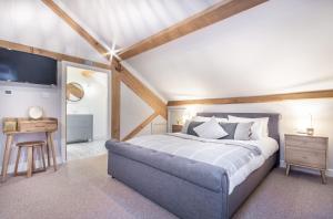 a bedroom with a large bed and a desk at Griffin Inn in Ruthin