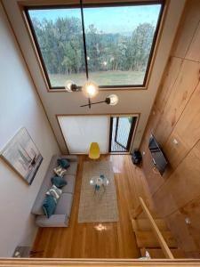 an overhead view of a living room with a large window at Cabañas Arrayanes de Huillinco en Chiloé in Chonchi