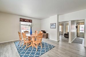 
a living room with a dining room table and chairs at Authentic Wausau Abode - half Mile to Downtown! in Wausau
