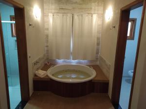 a small bathroom with a shower and a toilet at Pousada Alto dos Pinheiros in Monte Verde +37 photos