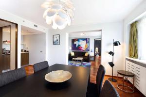 
a living room filled with furniture and a tv at Radisson Blu Hotel Lietuva in Vilnius
