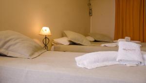 a hotel room with two beds with towels on them at Munay Salta in Salta