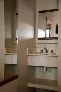 a bathroom with a sink and a mirror at Munay Salta in Salta +53 photos