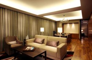 a living room with a couch and a table at LOTTE City Hotel Gimpo Airport in Seoul