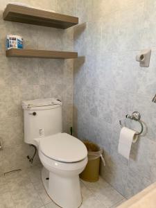 a bathroom with a white toilet in a room at Casa Oyamel, Private Room in the heart of cancun in Cancún