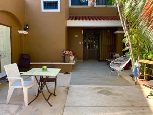 a patio with chairs and a table in front of a house at Casa Oyamel, Private Room in the heart of cancun in Cancún