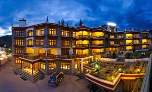 a large building with a car parked in front of it at Ladakh Residency in Leh
