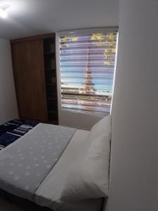 Ένα ή περισσότερα κρεβάτια σε δωμάτιο στο Aparta-Hotel Cafetero Oviedo