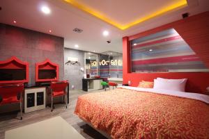 a hotel room with a red bed and a tv at Vov Hotel in Busan +32 photos