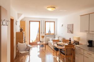 a kitchen and a living room with a table at Häuslerhof in Natz-Schabs
