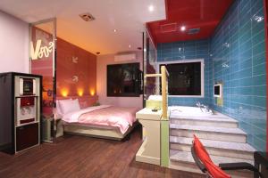 a bedroom with a bed and a sink and a tub at Vov Hotel in Busan +21 photos