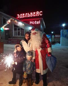 a group of people standing in front of a hotel at Edelweiss Hotel in Abzakovo