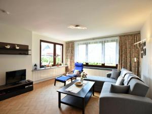 a living room with a couch and a table at Cozy Apartment in Klutz near Sea in Klütz