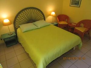 a bedroom with a large bed and some chairs at Locatlantique in Aytré
