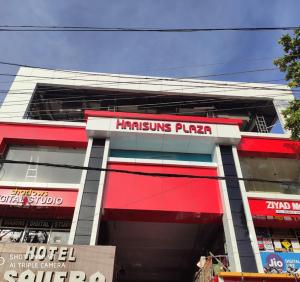 a building with a hammins pizza sign on it at Harisuns Plaza in Attingal