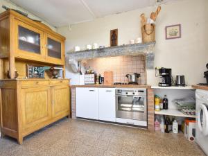 a kitchen with a stove and a white oven at Holiday home in nature near D cize in Decize