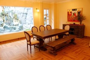 a dining room with a table and chairs and a window at Crazy House in Da Lat