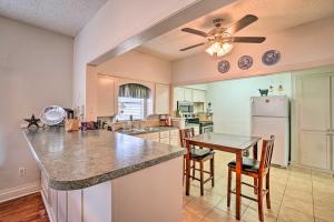 a kitchen with a table and a refrigerator at 4 Miles to Lake Jacksboro Cozy Texas Cottage in Jacksboro