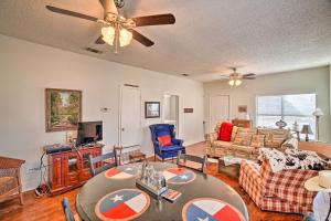 a living room with a table and a couch at 4 Miles to Lake Jacksboro Cozy Texas Cottage in Jacksboro