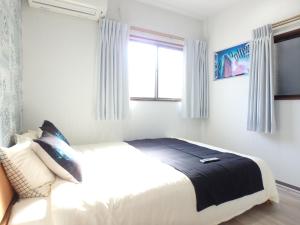 a bedroom with a bed and a window at Sakurajima Building in Osaka +29 photos