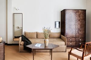 a living room with a couch and a table at Hotel Rochechouart - Orso Hotels in Paris