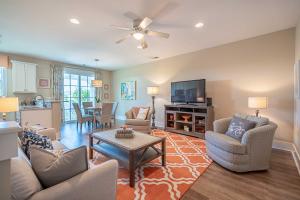 a living room with a couch and chairs and a table at Chic North Myrtle Beach Villa Resort Amenities! in Myrtle Beach