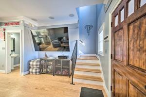 a hallway with blue walls and a wooden door and stairs at Modern Retreat about half Mi to Bryant-Denny Stadium in Tuscaloosa
