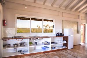 a kitchen with a counter and a window at Musica do Mar Beach Front Apartments, Ocean View in Praia do Tofo