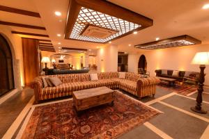 a large living room with couches and a rug at RAYMAR HOTELS MARDİN in Mardin