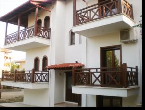a building with balconies on the side of it at Hotel Sarandos in Ammouliani