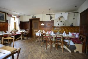 a dining room with tables and chairs in a restaurant at Alpengasthof zur Post in Schattwald +34 photos