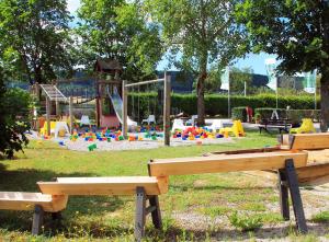 a park with two benches and a playground at TinyHausHotel Beilngries in Beilngries