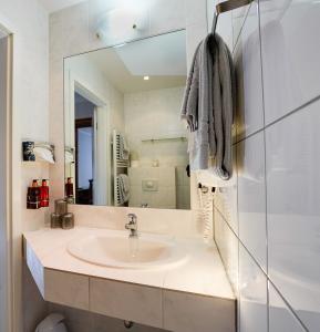 a bathroom with a sink and a mirror at Gästehaus Fuchshof in Nürburg +20 photos