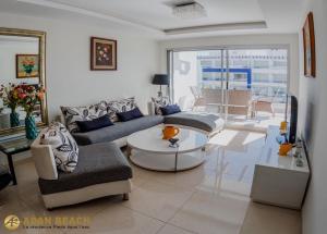a living room with a couch and a table at Adan Beach Residence, Beach Front Apartments in Aourir