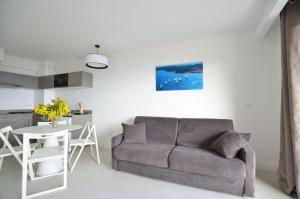 a living room with a couch and a table at La Perle d'Eze - Aparthotel in Éze