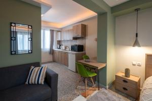 a living room with a couch and a table and a kitchen at Ririka Athens Homes - Cosy Apartments in Monastiraki, Athens Historical Centre in Athens +72 photos
