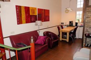 a living room with a couch and a table at Meschermolen 5 in Eijsden